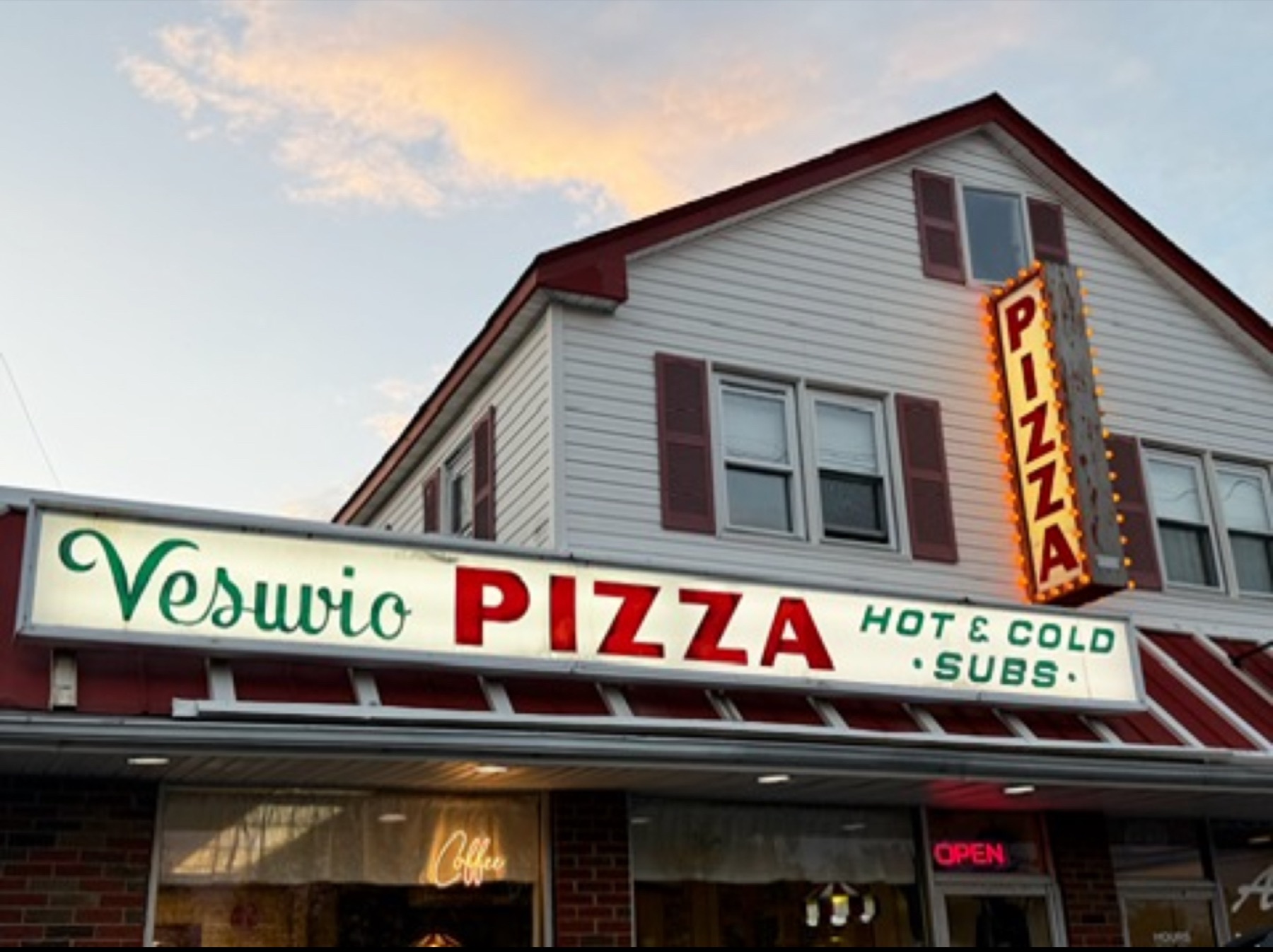The Vesuvios Pizza storefront sign at sunset in Point Pleasant, NJ
