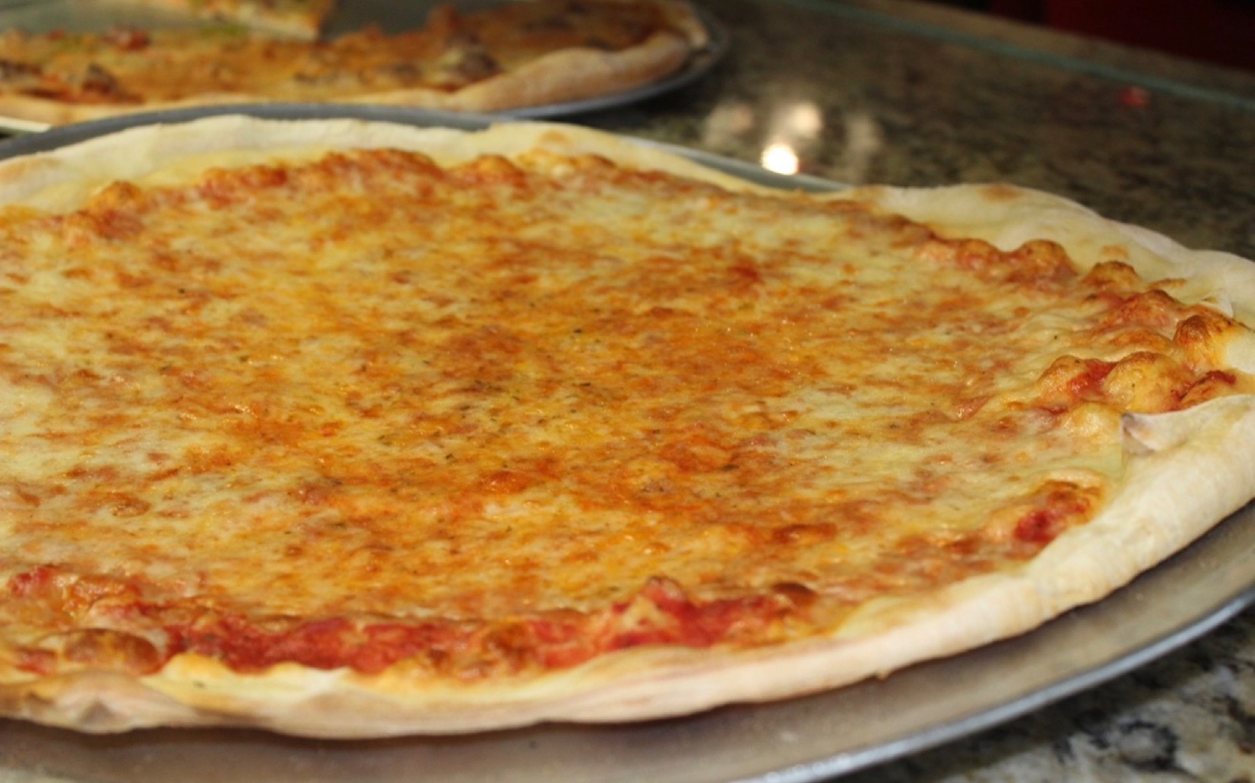 A fresh cheese pizza pie from Vesuvios Pizza